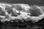 Black and White photograph with billowing Cumulus clouds ove the snow capped mountains in the Wrangell Range in Alaska.