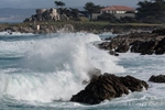 Colour photograph of waves crashing over rocks in Monterey Bay, California