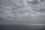 Colour photograph of Patches of sunlight make their way through the cloud cover, lighting up the English Channel