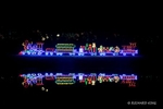 Colour photograph of Christmas Lights on a lake with a Steam Train, Carriges, Puffs of Smoke and a reflection
