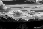 Black and White photograph with billowing Cumulus clouds over the snow capped mountains in the Wrangell Range in Alaska