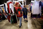Outfitted with new backpacks, two brothers shop for school clothes as they attend the Back to School Boost. Many charity organizations like Lutheran Social Services who sponsored the event, have seen an increase in families needing their help. Area businesses like Kohls donate clothing, school supplies and other items for the program.