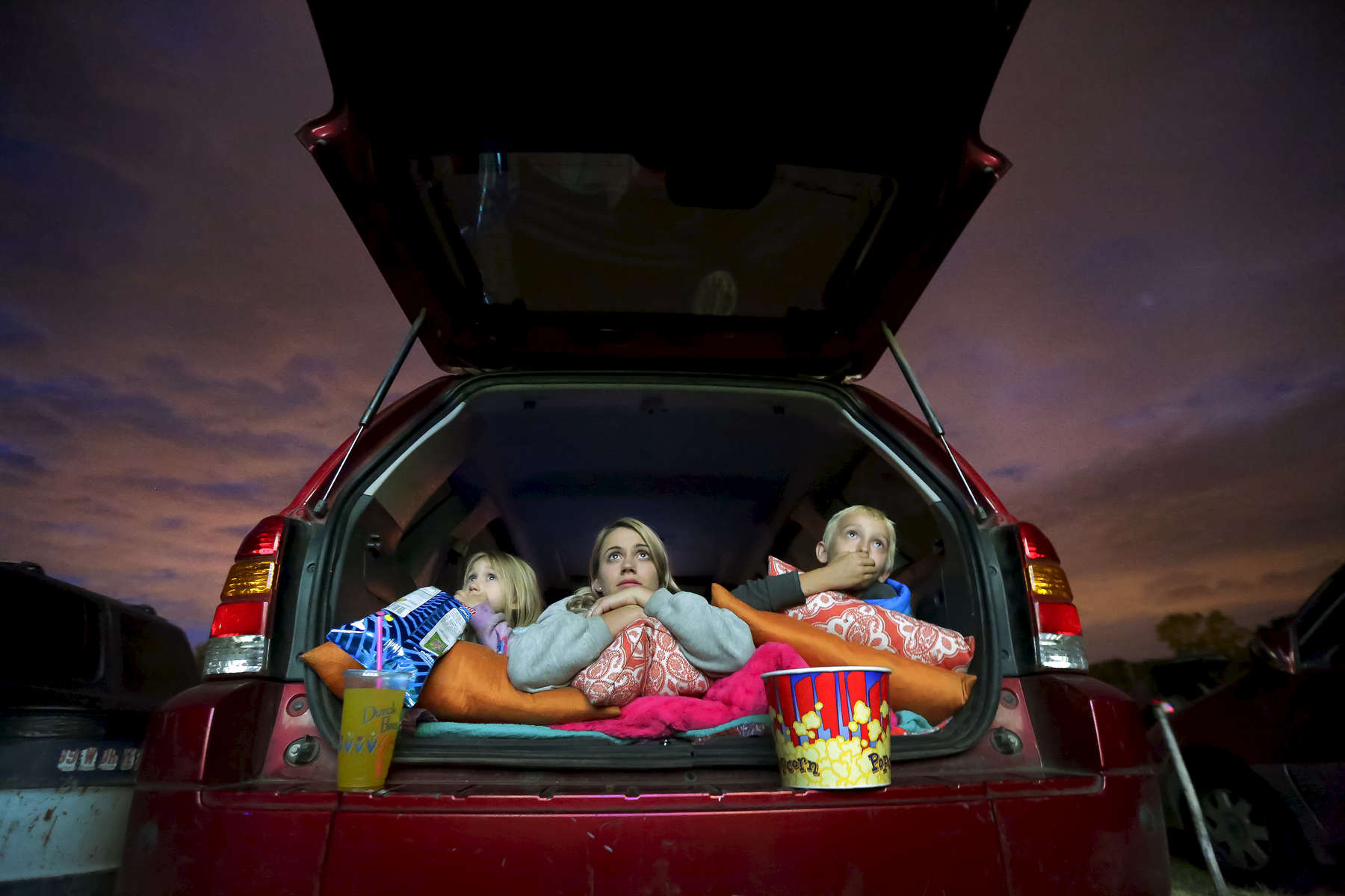 The Haight family from Grand Ronde (left to right) Hemi, 4, her mother Kiri, and Tommy, 8, watch the movie. Moviegoers enjoy a night at the theater at the 99W Drive-In Theatre in Newburg, June 18, 2016. The theatre opened in August 1953 and continues operating under the third-generation owner, Brian Francis. Kristyna Wentz-Graff/Staff