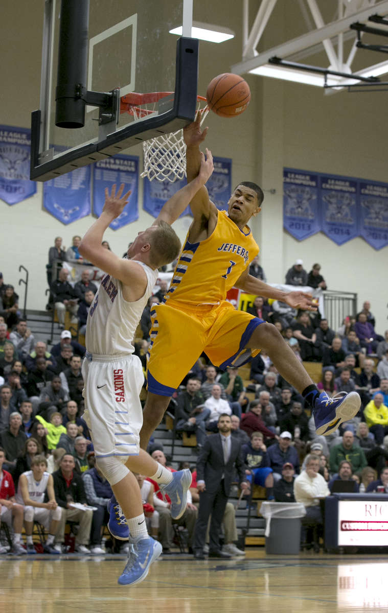 In the final seconds of the fourth quarter, South Salem's Gabe Matthews tries for the net but is blocked by Jefferson's Isaiah Robinson.