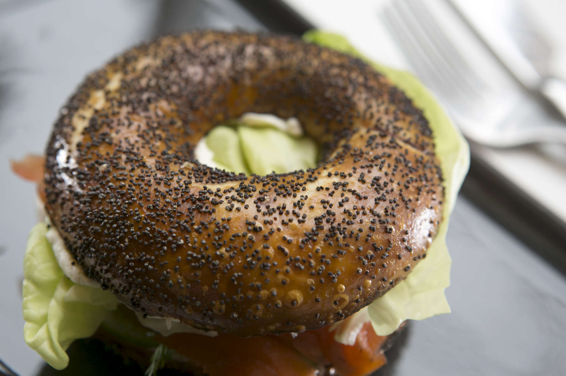 A smoked salmon bagel sandwich at Nuvrei in Portland, with toasted poppy seed bagel with cucumber, dill, red onion chive cream cheese and butter lettuce. 
