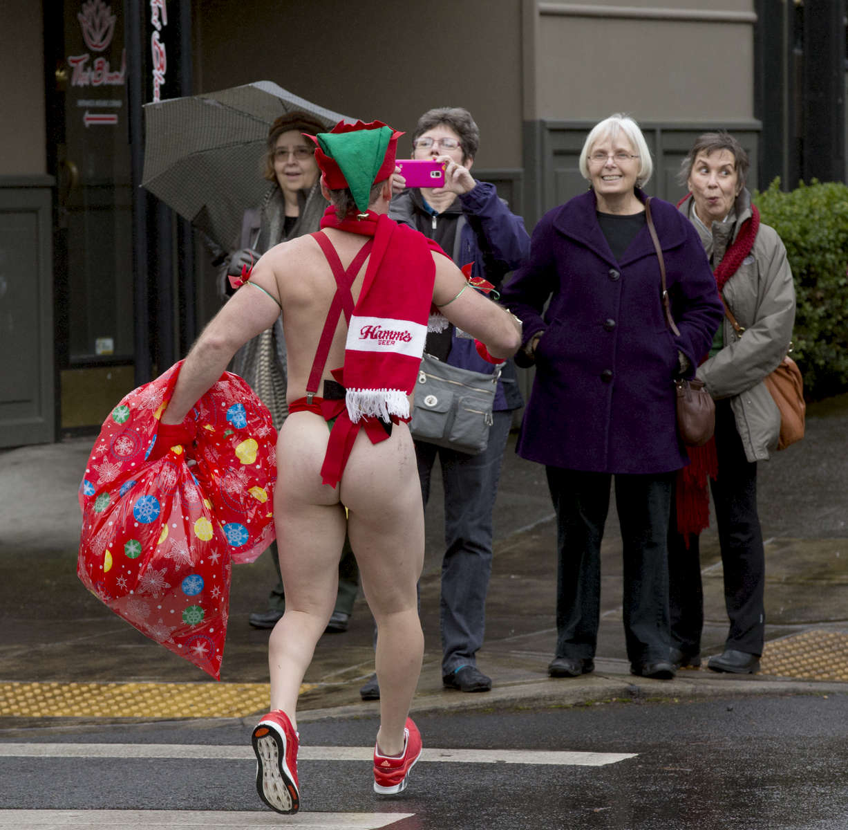 A Santa Speedo participant brings holiday cheer to onlookers as he runs through the streets in northwest Portland in 2014 during the Santa Speedo Run. The event is a fundraiser for the non-profit Ethiopia Project and raised $3000 dollars with the run.