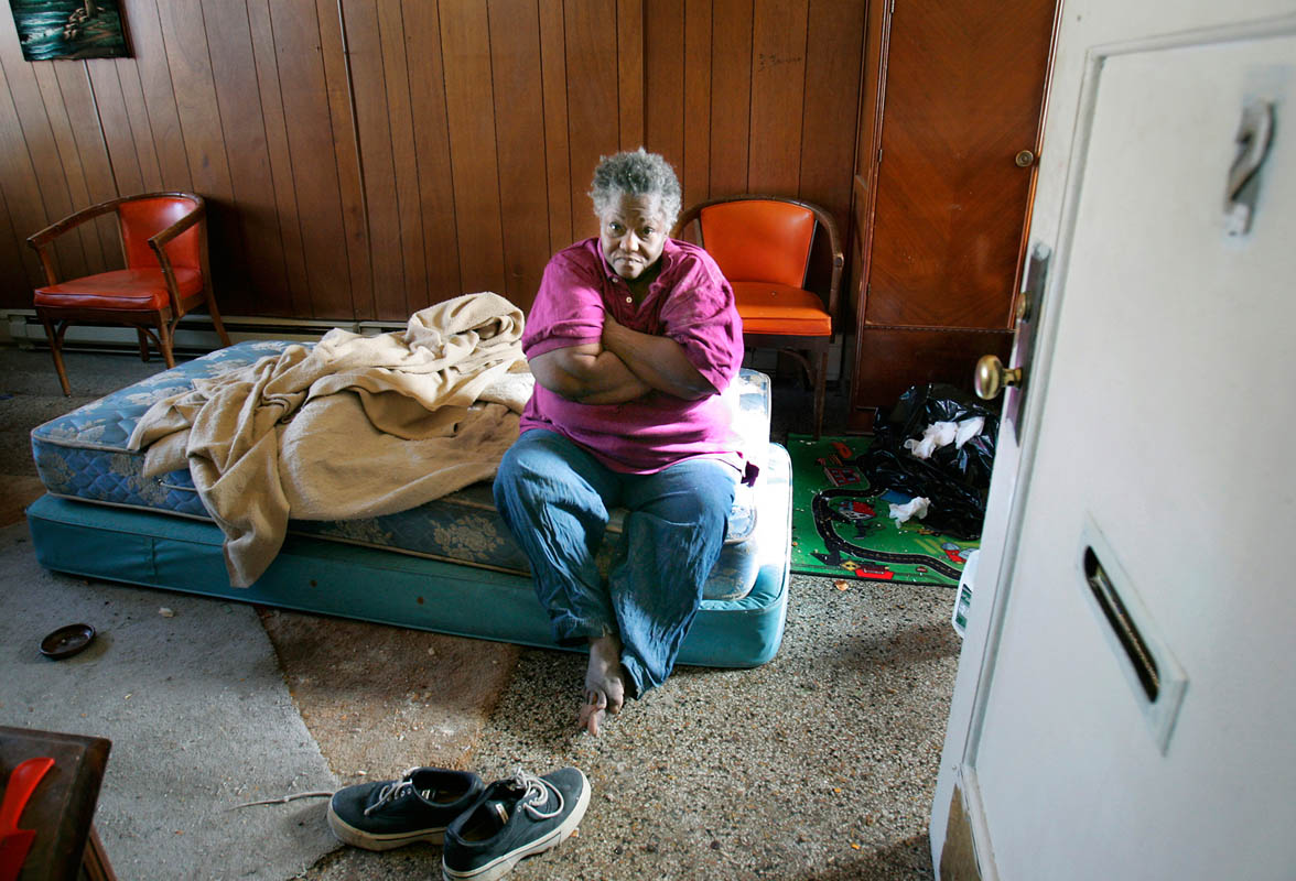 Bessie Johnson sits on a bare mattress soaked in her own urine, January 18, 2006, where she has lived for over 5 years at a boarding home in Milwaukee. 