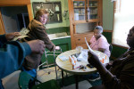 Landlord Dawn Powell, far left, is handed money to buy supplies for tenants at their Milwaukee home, January 31, 2006. Both Susan, center left, and Bessie, right, were patients at the mental hospital as a result of their chronic mental illness. Although both women have caseworkers, their lifes really are in the hands of the landlord, who is supposed to provide shelter and food.