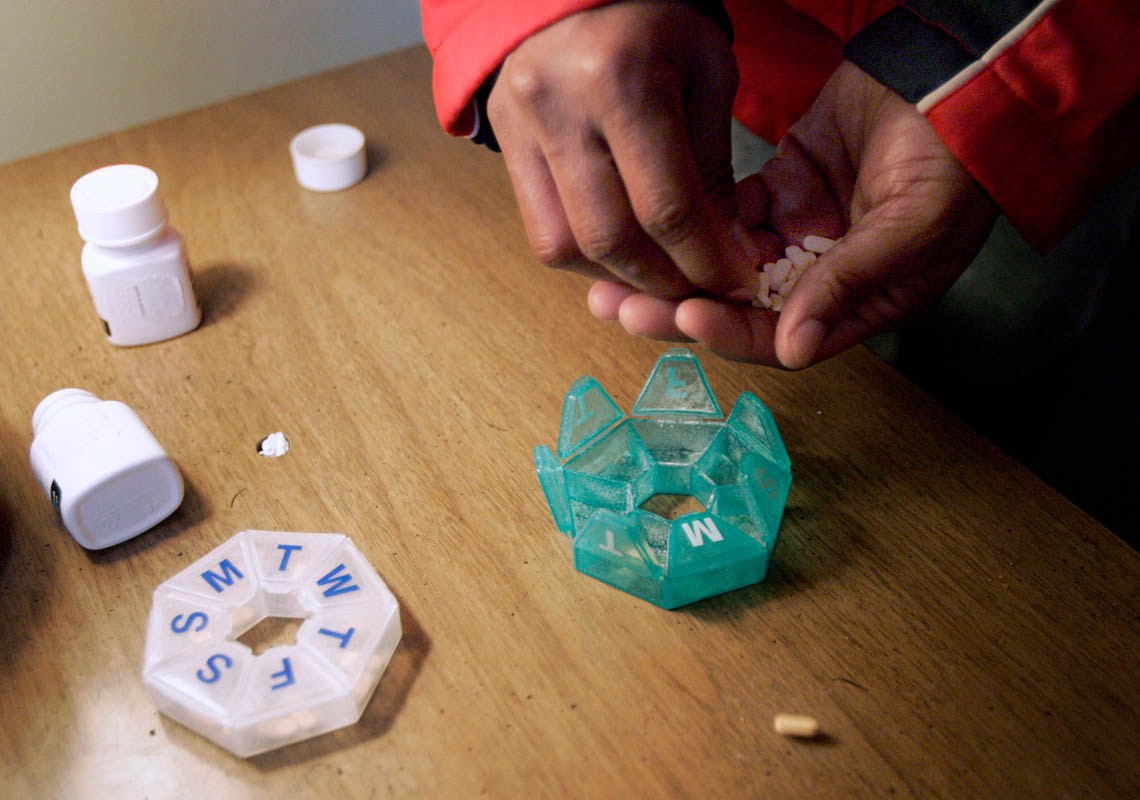 Maxine Lane sorts out her medication under the supervision of her case manager. Regulation of medication is left up to individuals although many are on a variety and large quantities of pills. Good case managers often help sort out the pills during visits, but there are many who are left to figure it out on their own.