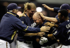 Casey McGehee is surrounded with teammates, including coach Ken Macha (left) after McGehee came up with a hit in the bottom of the 9th inning, on a full count, that scored two runs to give the Brewers the win over the Cubs.