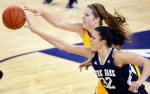 Marquette's Katherine Plouffe (left) and Notre Dame's Becca Bruszewski  sprint to gain control of the ball after Plouffe fumbled it during the first half of the game at the Al McGuire Center in Milwaukee.