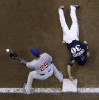 Craig Counsell dives back to first to beat the tag in the third inning of the Cubs vs. Brewers series at Miller Park