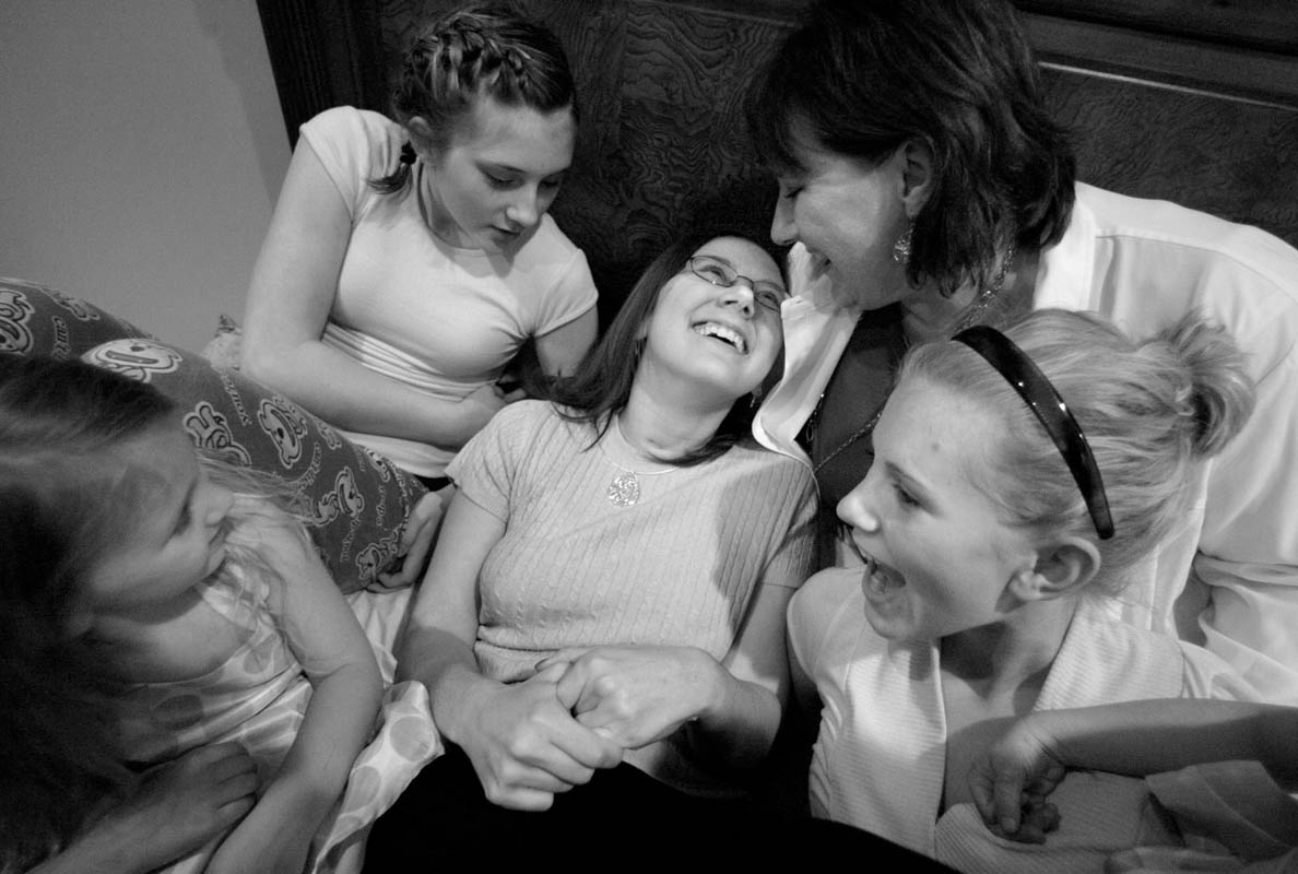 Courtney, center, is surrounded by neices Brooke Johnson, 16, far right, Baylee Johnson, 3, left, Brittney Henrie, 12, top left, Courtney's sister Juli Henrie, top right, as they relax in Courtney's room, April 8, 2007 in Genoa City. Courtney will live with her oldest sister Juli and her family, with all the nearby family members helping with her care.