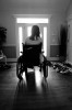 Courtney stares out the front door, alone in the hallway, after wheeling herself away from a family dinner. One aspect of Courtney's brain injury is intense frustration and quick mood changes that cause her to become very angry or solemn.