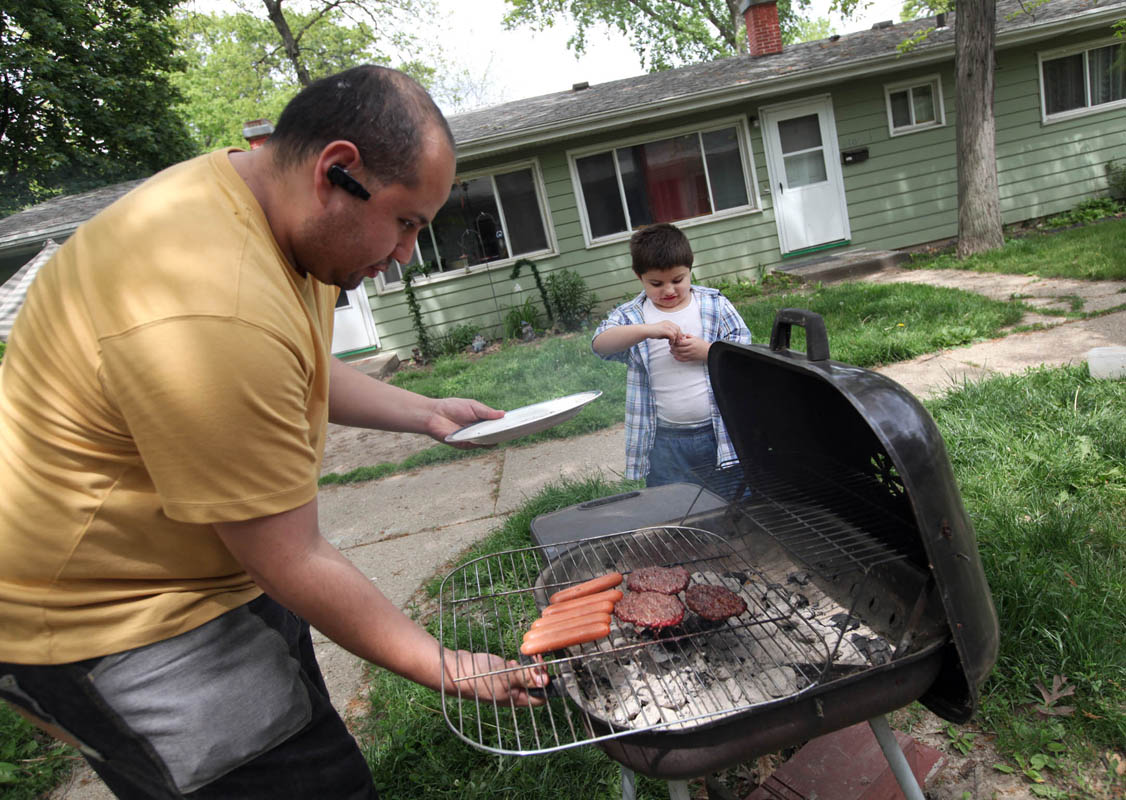 Izzy's father, Diego, flips burgers as the family grills at Izzy's home. Children become aware of their gender between 1 and 2 years of age.