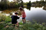 Izzy and older sister Angeliah hold hands while exploring a pond in Winnequah Park in Monona in August. Izzy's sisters had difficulty at first, calling Izzy 'she,' and then switching to 'he.'