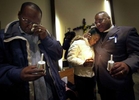 Kenny McClellan, grandfather to 13-month-old Christopher Thomas, Jr., (left) wipes his tears as his daughter Shantrina Freeman, 12, (center) is comforted by minister Gregory Lewis, (right) following a candlelight vigil held for Christopher Thomas, Jr. The toddler was placed in the home of his aunt Crystal Keith, by the Bureau of Milwaukee Child Welfare. Signs of violent child abuse were not recognized by the caseworker, and Thomas died of injuries after a severe beating by his aunt.