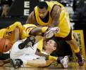 UW-Milwaukee Panther Paige Paulsen, center, is caught in a tangle of legs and arms as he scrabbles for a loose ball against Central Michigan's Jeremy Allen, far left, and Nate Minnoy, right, during Wednesday night's game at the U.S. Cellular Arena.