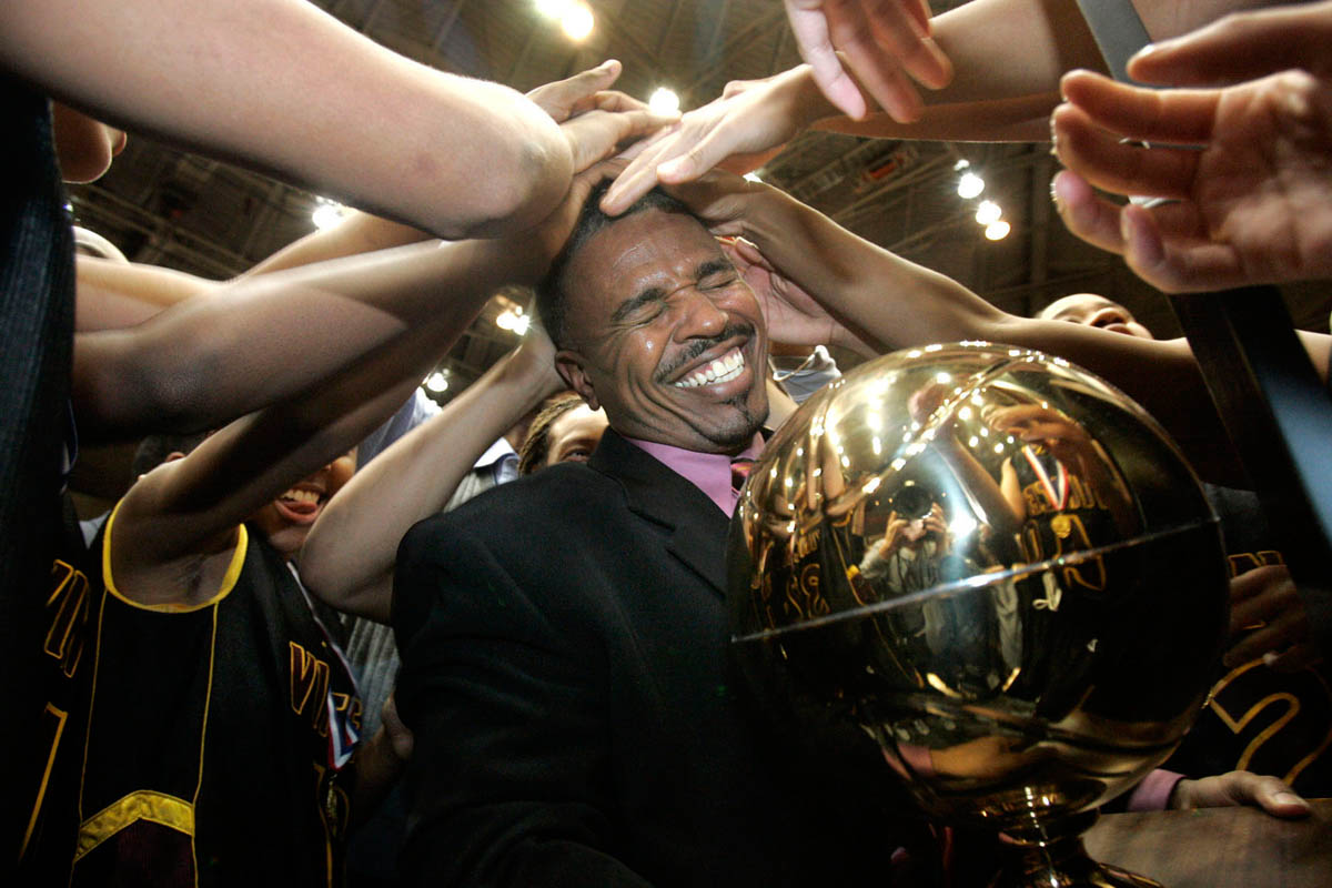 Milwaukee Vincent basketball players rub the head of their head coach Marquis Hines, after winning the state WIAA Division 1 championship at the Alliant Energy Center in Madison, Wis.. This was the first state title for the team, who defeated Sheboygan North, 49-45.