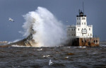 Strong gusting winds drive the waves into the Milwaukee Harbor Lighthouse during a winter storm. The waves were easily clearing the 61-foot tall lighthouse with winds reaching up to 60 miles per hour. 