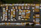 An aerial view of parked school buses in a parking lot bus depot on April 25, 2020 in Freeport, New York. Freeport schools have been closed since March 16th because of the coronavirus pandemic.   