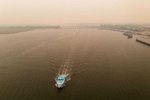 An aerial view of a boat on the ocean enveloped in a dense haze caused by wildfires in Canada on June 07, 2023 in Point Lookout, New York.  Over 100 wildfires are burning in the Canadian province of Nova Scotia and Quebec resulting in air quality health alerts for the Adirondacks, Eastern Lake Ontario, Central New York and Western New York.  New York topped the list of most polluted major cities in the world on Tuesday night, as smoke from the fires continues to blanket the East Coast. 
