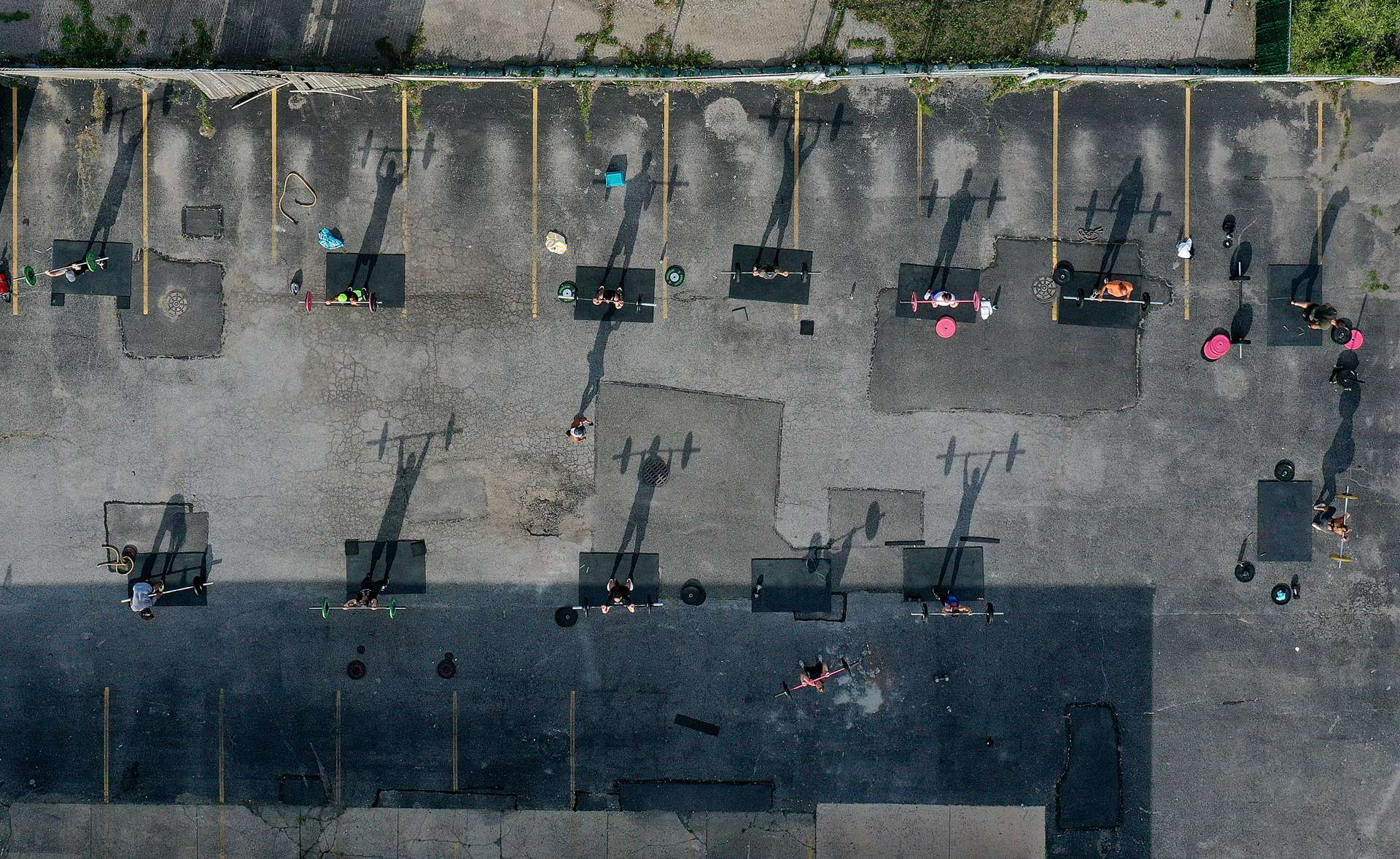 An aerial view of Fitness Instructor Dennis Guerrero leading an outdoor Jetty Gym {quote}Outside The Box{quote} fitness workout on July 20, 2020 in Oceanside, New York.  New York Governor Andrew Cuomo announced that gyms will not be permitted to reopen during phase 4 until New York's Health Department determines if air filtering systems are circulating the coronavirus. More than 3,900,000 people in the United States alone have been infected with the coronavirus and at least 143,000 have died.  