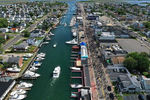 An aerial view of Protesters marching along the Nautical Mile on June 07, 2020 in Freeport, New York.  Minneapolis Police officer Derek Chauvin was filmed kneeling on George Floyd's neck, who was later pronounced dead at a local hospital. Chauvin has been charged with second-degree murder and three other officers who participated in the arrest have been charged with aiding and abetting second-degree murder. Floyd's death, the most recent in a series of deaths of black Americans by the police, has set off days and nights of protests across the country.  
