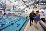 United States Paralympian Anastasia Pagonis is assisted by her coach Darryn Solotoff as she heads to a pool training session at Nassau County Aquatic Center on May 25, 2024 in East Meadow, New York.  Pagonis has autoimmune retinopathy which led her sight to decrease at the age of 11, and she lost her vision by the age of 14.  She competed in the swimming competition at the Tokyo 2020 Paralympic Games where she won a gold and bronze medal respectively in the 400m Freestyle S11 and 200-meter Individual Medley S11.  An S11 athlete is the most severe form of visual impairment. S11 swimmers all swim with blacked-out goggles to ensure a level playing field, blocking out all light so it's like swimming with a blindfold. She will be competing in the 400m Freestyle S11 at the 2024 Paralympic Games this summer in Paris, France. 