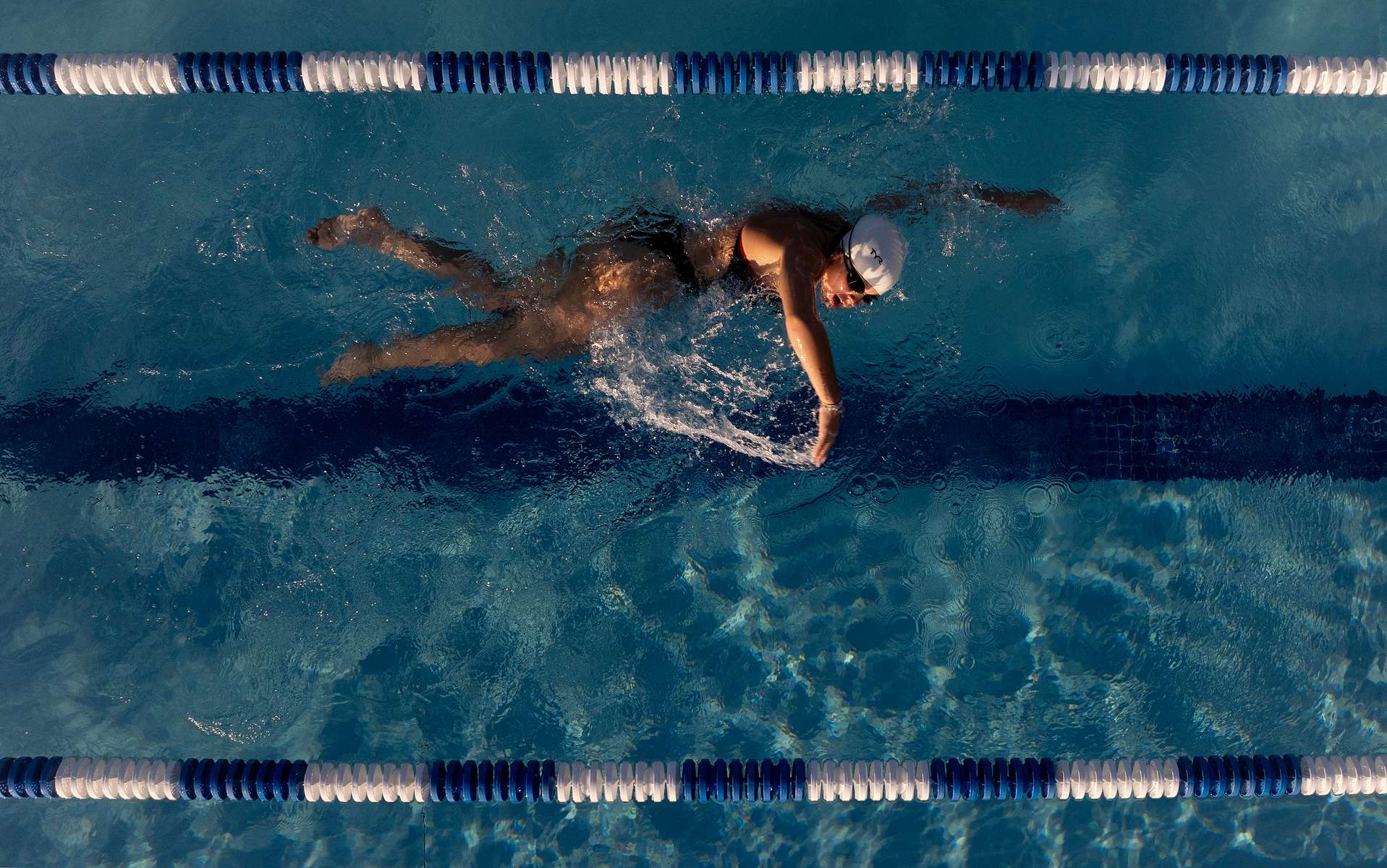 In this aerial view, United States Paralympian Anastasia Pagonis swims during a training session on June 1, 2024 in Syosset, New York.  Pagonis has autoimmune retinopathy which led her sight to decrease at the age of 11, and she lost her vision by the age of 14.  She competed in the swimming competition at the Tokyo 2020 Paralympic Games where she won a gold and bronze medal respectively in the 400m Freestyle S11 and 200-meter Individual Medley S11.  An S11 athlete is the most severe form of visual impairment. S11 swimmers all swim with blacked-out goggles to ensure a level playing field, blocking out all light so it's like swimming with a blindfold.  This is why they typically swim on the lane line and have tappers to inform them when they need to turn or stop.  She will be competing in the 400m Freestyle S11 at the 2024 Paralympic Games this summer in Paris, France. 