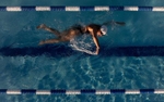 In this aerial view, United States Paralympian Anastasia Pagonis swims during a training session on June 1, 2024 in Syosset, New York.  Pagonis has autoimmune retinopathy which led her sight to decrease at the age of 11, and she lost her vision by the age of 14.  She competed in the swimming competition at the Tokyo 2020 Paralympic Games where she won a gold and bronze medal respectively in the 400m Freestyle S11 and 200-meter Individual Medley S11.  An S11 athlete is the most severe form of visual impairment. S11 swimmers all swim with blacked-out goggles to ensure a level playing field, blocking out all light so it's like swimming with a blindfold.  This is why they typically swim on the lane line and have tappers to inform them when they need to turn or stop.  She will be competing in the 400m Freestyle S11 at the 2024 Paralympic Games this summer in Paris, France. 