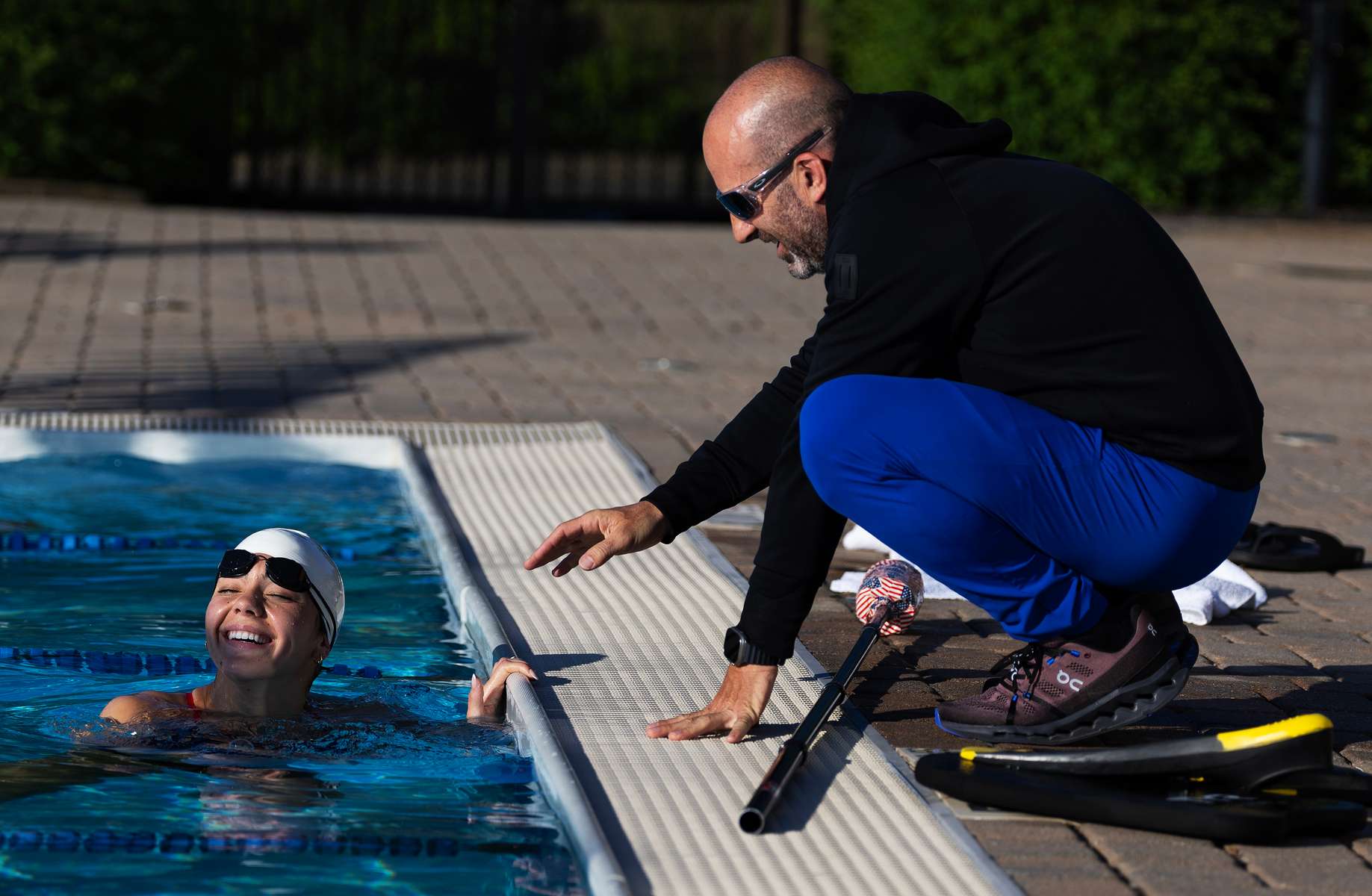 United States Paralympian Anastasia Pagonis talks to her coach Darryn Solotoff during a training session on June 01, 2024 in Syosset, New York.  Pagonis has autoimmune retinopathy which led her sight to decrease at the age of 11, and she lost her vision by the age of 14.  She competed in the swimming competition at the Tokyo 2020 Paralympic Games where she won a gold and bronze medal respectively in the 400m Freestyle S11 and 200-meter Individual Medley S11.  An S11 athlete is the most severe form of visual impairment. S11 swimmers all swim with blacked-out goggles to ensure a level playing field, blocking out all light so it's like swimming with a blindfold.  This is why they typically swim on the lane line and have tappers to inform them when they need to turn or stop.  She will be competing in the 400m Freestyle S11 at the 2024 Paralympic Games this summer in Paris, France. 