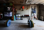 Dennis Guerrero trains in his garage at his home on May 13, 2020 in Long Beach, New York.  Dennis is an Amateur boxer and has competed in the New York City Golden Gloves.  He also owns a CrossFit Gym called CrossFit Jetty in Oceanside, New York. He was training to compete in this year's Golden Gloves tournament but it has been cancelled due to the coronavirus pandemic.  He also co owns a CrossFit Gym called CrossFit Jetty.  His gym has been closed by New York Governor Andrew Cuomo since March 16th due to the coronavirus COVID-19 pandemic.  Until the gyms are deemed safe to open he will continue to stay fit by training at home with the hope that he can box again later this year. 
