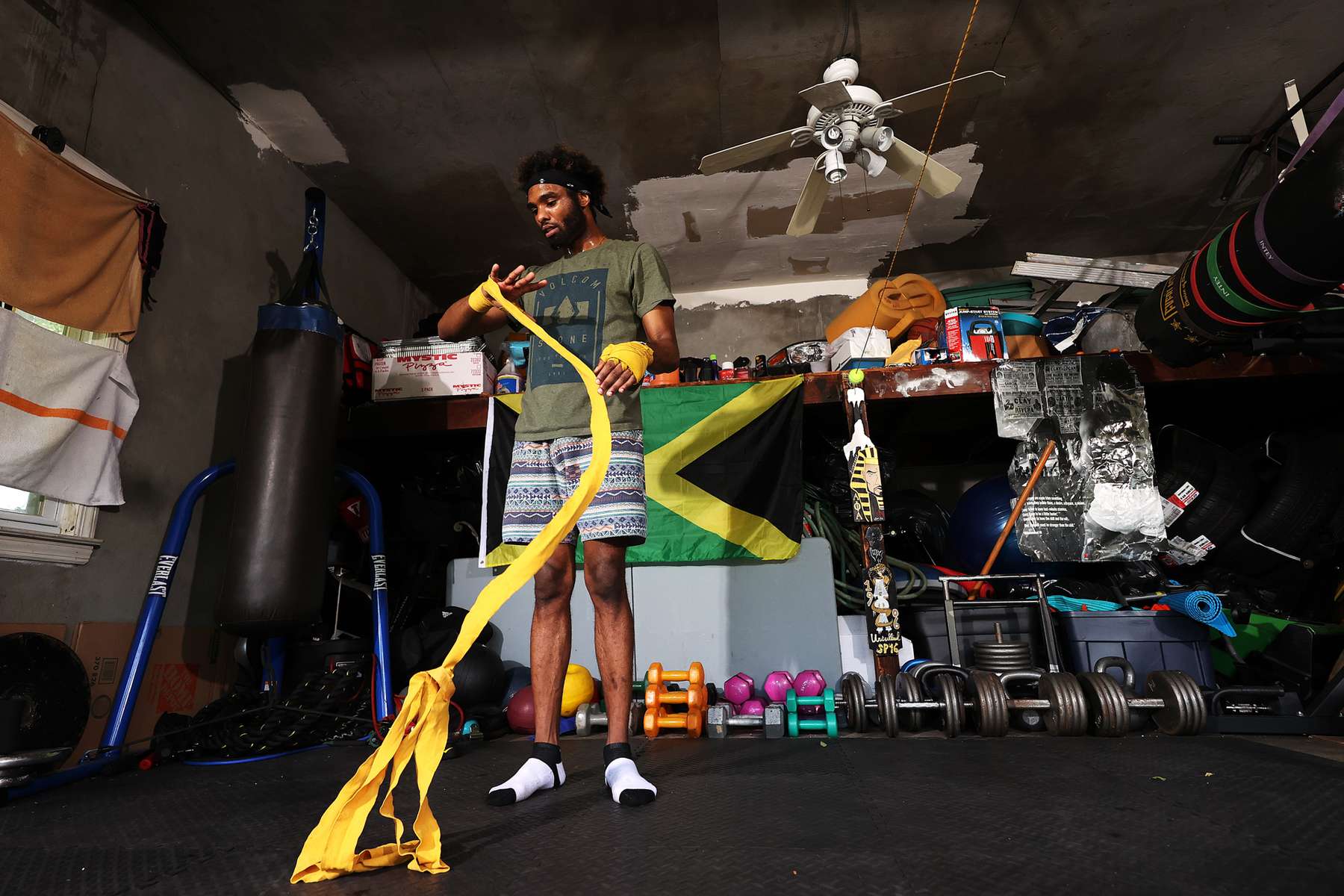 Khamall Dunkley wraps his hands in his training partner's garage on May 20, 2020 in Freeport New York.  Khamall is an Amateur boxer who fought in the New York City Golden Gloves and made the Quarter Finals in the Novice 141lb class. He was training to compete in this year's Golden Gloves tournament in the Open Class but it has been cancelled due to the coronavirus pandemic. The Gym he fights for, the Freeport Boxing Club, has been closed since March 16th. Until gyms are deemed safe to open he will continue to stay fit by training at home with the hope that he can box again later this year. 