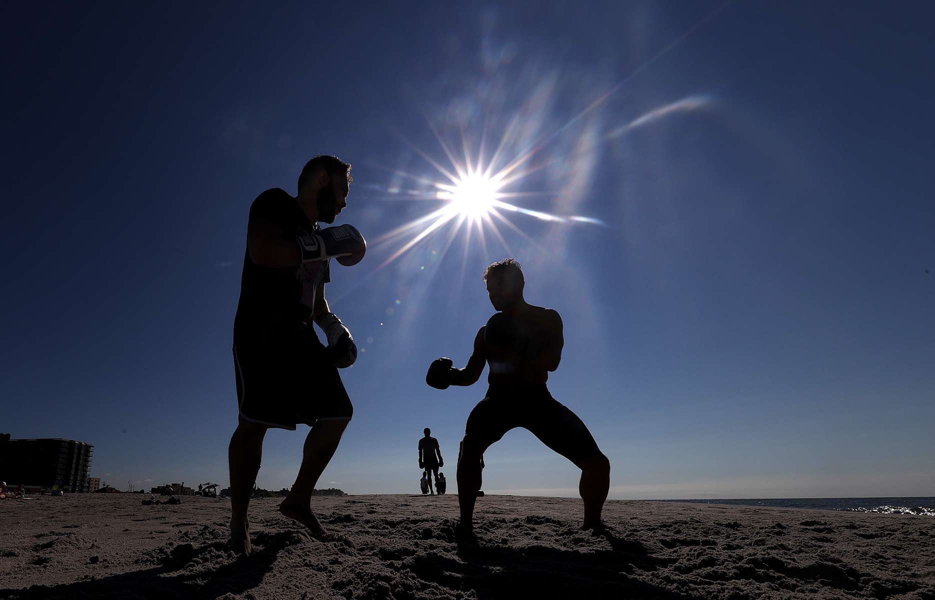 LONG BEACH, NEW YORK - AUGUST 18:  Members of the {quote}Life Outside the Box{quote} fitness club participate in a boxing sparring session at the beach on August 18, 2020 in Long Beach, New York.  Gyms, which have been closed in New York since mid-March to help prevent the spread of the coronavirus, will be allowed to open again as soon as August 24th Governor Andrew Cuomo has announced.  Gyms will be limited to a third of their capacity, and they need to maintain a sign-in sheet to help contact tracers in case of a virus outbreak. Air filters must be able to help prevent the transmission of viral particles. People must wear masks at all times (Photo by Al Bello/Getty Images)