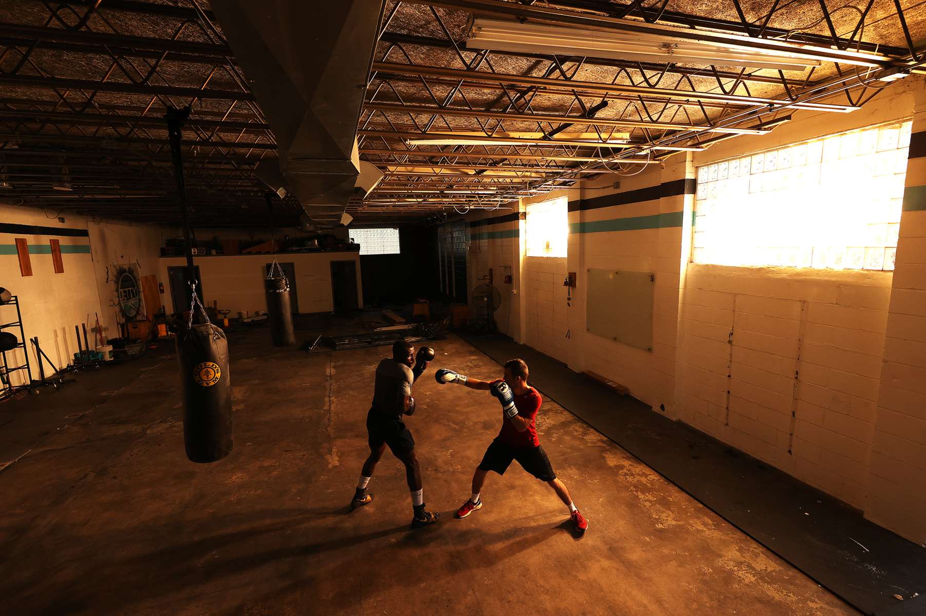 Recreational boxer Raheem Yusuff (left) spars with three time New York Golden Gloves boxer Anthony Lopez  during training session in a warehouse that was once Jetty gym on July 30, 2020 in Oceanside, New York. Dennis Guerrero, who is a co owner of Jetty has tried to hold many types of outdoor and open air workouts while the gym remains closed due to the coronavirus pandemic.  Since all gyms in New York had been closed since March 13, they have been trying to keep up financially to sustain the gym. Guerrero and his partner Michael Levitz have decided to closed their doors for good next week.  They will be moving their workouts online and at select locations.  Governor Andrew Cuomo announced that gyms will not be permitted to reopen during phase 4 until New York's Health Department determines if air filtering systems are circulating the coronavirus. More than 4,540,000 people in the United States alone have been infected with the coronavirus and at least 154,000 have died.  