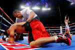 Mike Ruiz of Puerto Rico is checked on by referee Eddie Claudio after getting knocked out by Glen Tapia of the United States during their Super Welterweight fight at Madison Square Garden on December 3, 2011 in New York City.