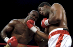 4 Nov 1995:  Evander Holyfield takes a uppercut to the jaw by Riddick Bowe during the fight at Caesars Palace in Las Vegas, Navada.Mandatory Credit: Al Bello  /Allsport