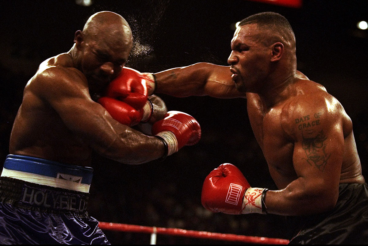 9 Nov 1996:  Mike Tyson hits Evander Holyfield before losing by TKO in the 11th round during their bout at the MGM Grand Garden in Las Vegas, Nevada. 