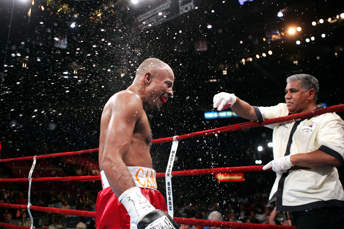 Bebis Mendoza (red shorts) is doused with water during a break in the fight with Rosendo Alvarez for the WBA light flyweight title at Madison Square Garden on October 2, 2004 in New York City. Rosendo Alvarez defeated Bebis Mendoza. 