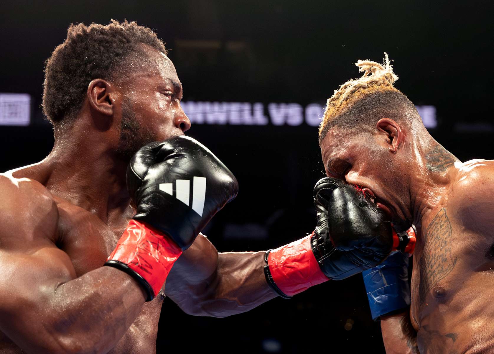 Charles Conwell (green trunks) punches Nathaniel Gallimore (orange trunks) during their Super Welterweight bout at Barclays Center on April 20, 2024 in New York City.  