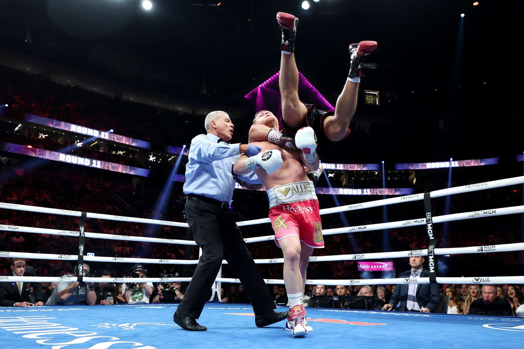 Canelo Alvarez (C) picks up Dmitry Bivol during their WBA light heavyweight title fight at T-Mobile Arena on May 07, 2022 in Las Vegas, Nevada. Bivol retained his title by unanimous decision. 
