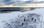 An aerial view of a game of football is played on the beach after a large winter storm passed through the area. Much of the Northeast is experiencing snow, wind and freezing temperatures with many businesses closed and schools in New York City going remote for the day.on February 13, 2024 in Long Beach, New York.