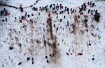 An aerial view of  people sledding after a large winter storm passed through the area on February 13, 2024 in Seaford, New York.  Much of the Northeast is experiencing snow, wind and freezing temperatures with many businesses closed and schools in New York City going remote for the day. 