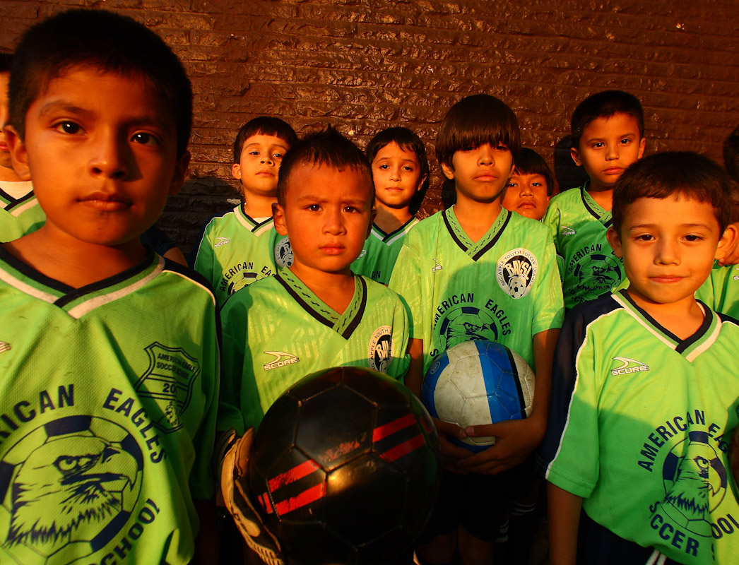 A boys soccer team poses before practice as their adult relatives participate in the Fedeiguayas Soccer League on September 5, 2007 at Flushing Meadows Park in Queens, New York. 