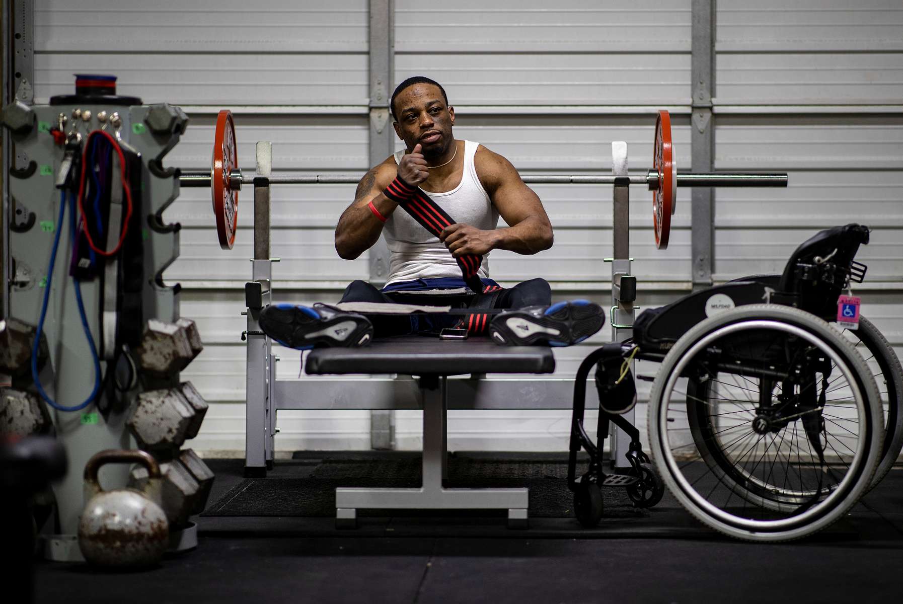 Team USA Para Powerlifter Garrison Redd wraps his wrists before bench pressing with his legs strapped to the bench to secure his body in place during a training session at Gaglione Strength Gym on April 07, 2021 in Farmingdale, New York. 
