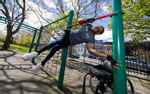 Team USA Para Powerlifter Garrison Redd does a flag pole hold out of his wheel chair on the Monkey Bars in Robert E. Venable Park on April 13, 2021 in Brooklyn, New York. 