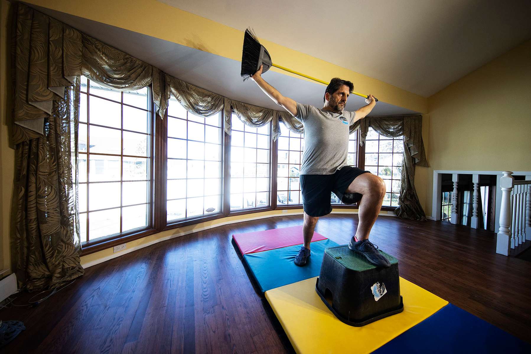 Jeff Levine exercises in his home with his virtual Fitness Trainer Dennis Guerrero on November 10th, 2020 in Oceanside, New York.  In March of 2014, Dennis Guerrero and his business partner opened a gym on Long Island. The pair shared a passion for fitness, a dream of creating a local community of like-minded people and a willingness to take a risk. Over the next six years, hundreds of members experienced and embraced a unique environment that fostered a palpable energy, helping athletes of all ages and abilities reach their potential.  The gym became a place to share achievements, work through losses and overcome illness. But like so many other businesses, it seemingly had no way of overcoming the financial impact and ongoing uncertainty of a global pandemic. With the arrival of Covid-19, the gym shut its doors back in March, with no idea when it would reopen. The owners, though, were far from done. They lent out every piece of equipment they owned to the gym’s members, continued to pay their staff and worked to set up outdoor classes in hopes of keeping their membership active and healthy. As the shutdown stretched on, it became clear that the physical gym was closed for good.  They have since reinvented themselves and are now called Life Outside the Box.  Their business model has changed drastically, and all their workouts have gone virtual.  The workouts are conducted by a small group of fitness trainers led by Guerrero.  The members pay a monthly fee and can take live Zoom fitness classes.  They are coached by the virtual trainers in real time.  More and more people have reconstructed their garages, spare rooms, backyards, and basements into home gyms since the COVID-19 pandemic hit the United States. 