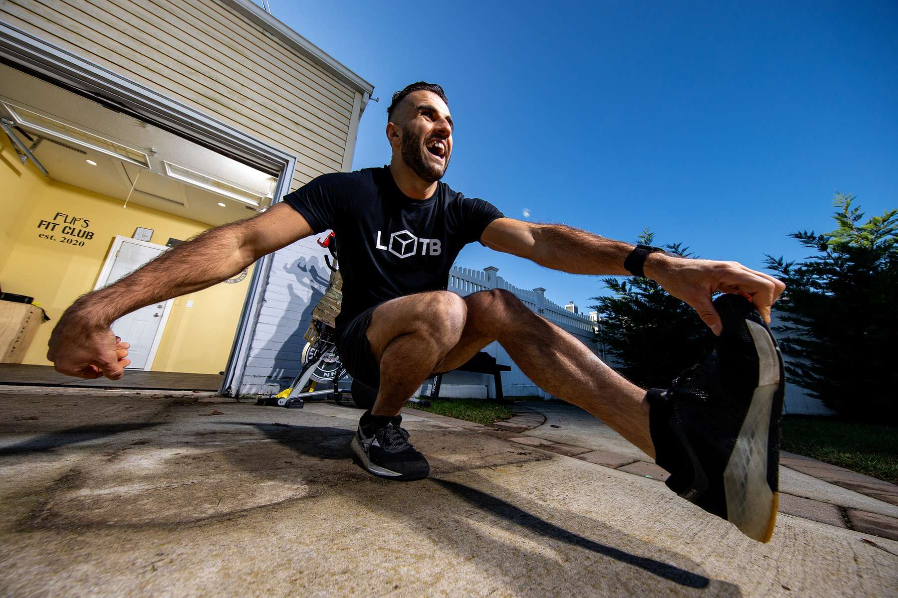 John Puccio exercises outside his friend's garage with his virtual Fitness Trainer Dennis Guerrero on November 14th, 2020 in Oceanside, New York.  In March of 2014, Dennis Guerrero and his business partner opened a gym on Long Island. The pair shared a passion for fitness, a dream of creating a local community of like-minded people and a willingness to take a risk. Over the next six years, hundreds of members experienced and embraced a unique environment that fostered a palpable energy, helping athletes of all ages and abilities reach their potential.  The gym became a place to share achievements, work through losses and overcome illness. But like so many other businesses, it seemingly had no way of overcoming the financial impact and ongoing uncertainty of a global pandemic. With the arrival of Covid-19, the gym shut its doors back in March, with no idea when it would reopen. The owners, though, were far from done. They lent out every piece of equipment they owned to the gym’s members, continued to pay their staff and worked to set up outdoor classes in hopes of keeping their membership active and healthy. As the shutdown stretched on, it became clear that the physical gym was closed for good.  They have since reinvented themselves and are now called Life Outside the Box.  Their business model has changed drastically, and all their workouts have gone virtual.  The workouts are conducted by a small group of fitness trainers led by Guerrero.  The members pay a monthly fee and can take live Zoom fitness classes.  They are coached by the virtual trainers in real time.  More and more people have reconstructed their garages, spare rooms, backyards, and basements into home gyms since the COVID-19 pandemic hit the United States. 
