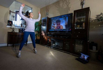 Alexa Hoovis exercises in her home with her virtual Fitness Trainer Dennis Guerrero on November 20th, 2020 in Oceanside, New York.  In March of 2014, Dennis Guerrero and his business partner opened a gym on Long Island. The pair shared a passion for fitness, a dream of creating a local community of like-minded people and a willingness to take a risk. Over the next six years, hundreds of members experienced and embraced a unique environment that fostered a palpable energy, helping athletes of all ages and abilities reach their potential.  The gym became a place to share achievements, work through losses and overcome illness. But like so many other businesses, it seemingly had no way of overcoming the financial impact and ongoing uncertainty of a global pandemic. With the arrival of Covid-19, the gym shut its doors back in March, with no idea when it would reopen. The owners, though, were far from done. They lent out every piece of equipment they owned to the gym’s members, continued to pay their staff and worked to set up outdoor classes in hopes of keeping their membership active and healthy. As the shutdown stretched on, it became clear that the physical gym was closed for good.  They have since reinvented themselves and are now called Life Outside the Box.  Their business model has changed drastically, and all their workouts have gone virtual.  The workouts are conducted by a small group of fitness trainers led by Guerrero.  The members pay a monthly fee and can take live Zoom fitness classes.  They are coached by the virtual trainers in real time.  More and more people have reconstructed their garages, spare rooms, backyards, and basements into home gyms since the COVID-19 pandemic hit the United States.  